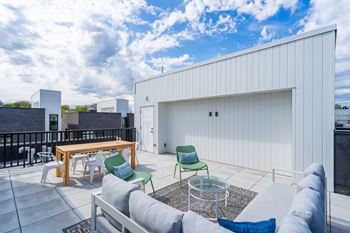 A patio with a couch and chairs and a table